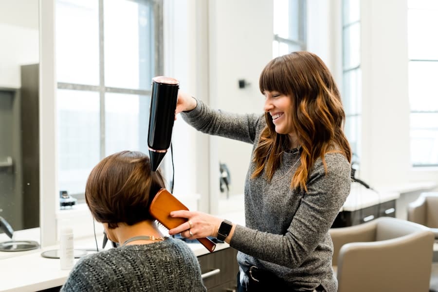 Stylist blow-drying a client's hair